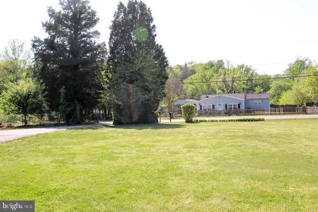 a view of a swimming pool with an outdoor seating and a yard