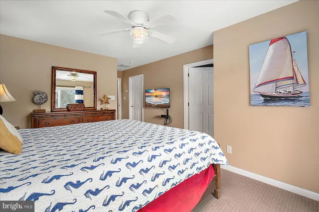 a bedroom with a bed and painting on the wall