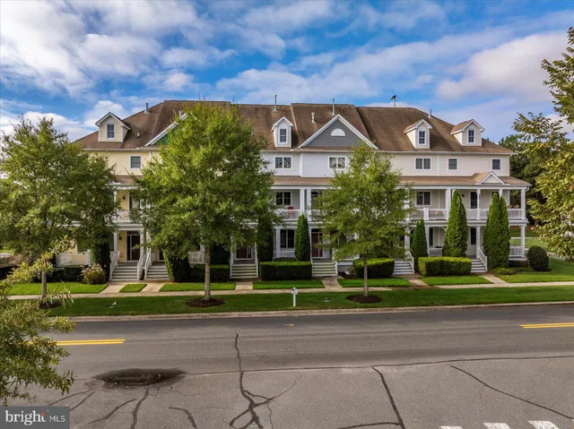 a front view of a building with a garden