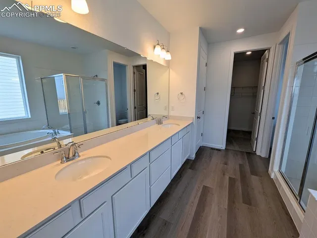 a spacious bathroom with a double vanity sink and mirror