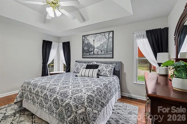 a bedroom with a large bed and a chandelier