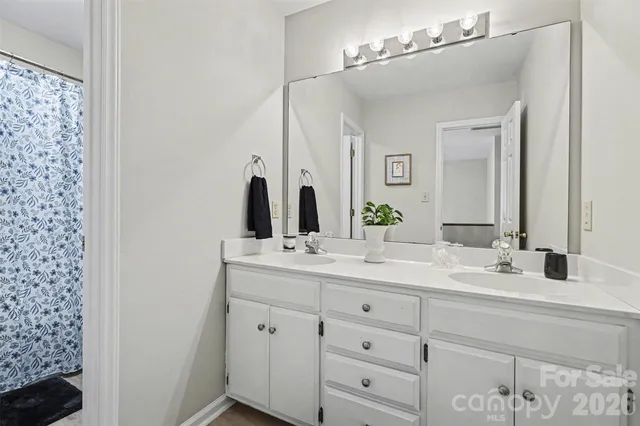 a bathroom with a double vanity sink and a mirror