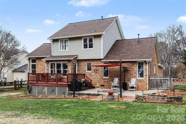a view of a house with garden and chairs