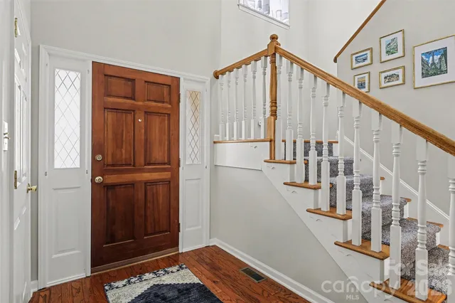 a view of entryway with wooden floor and stairs