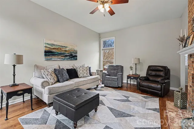 a living room with furniture a rug and a lamp