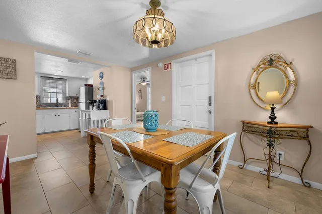 a view of a dining room with furniture and a chandelier