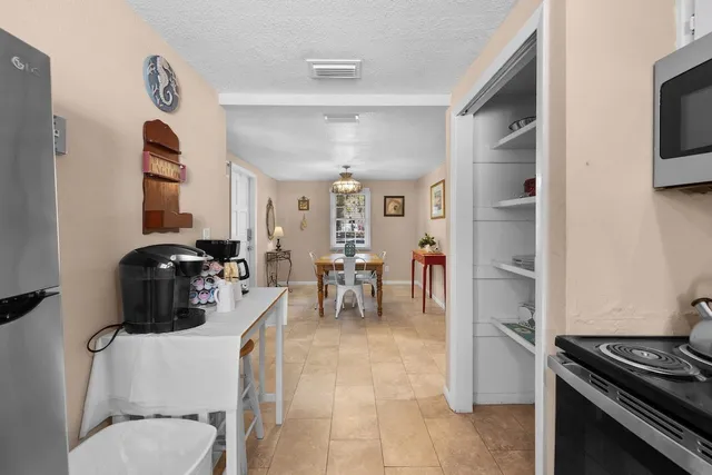 a kitchen with stainless steel appliances granite countertop a stove and a refrigerator