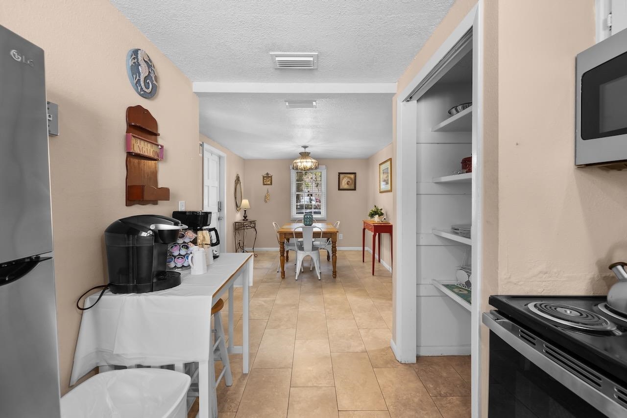 118 Pomar Street St. Augustine, FL 32084 - Photo 13 of 23 a kitchen with stainless steel appliances granite countertop a stove and a refrigerator