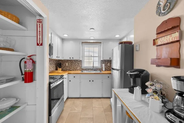 a kitchen with refrigerator and window