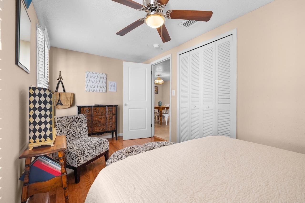 118 Pomar Street St. Augustine, FL 32084 - Photo 15 of 23 a bedroom with a bed and a chandelier