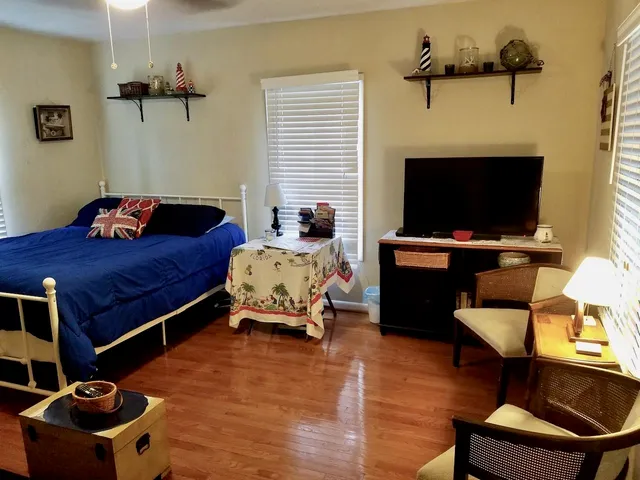 a bedroom with a bed and a flat screen tv