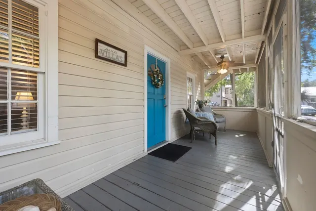 a view of a porch with wooden floor and furniture