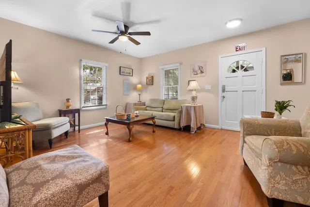 a living room with furniture and a wooden floor
