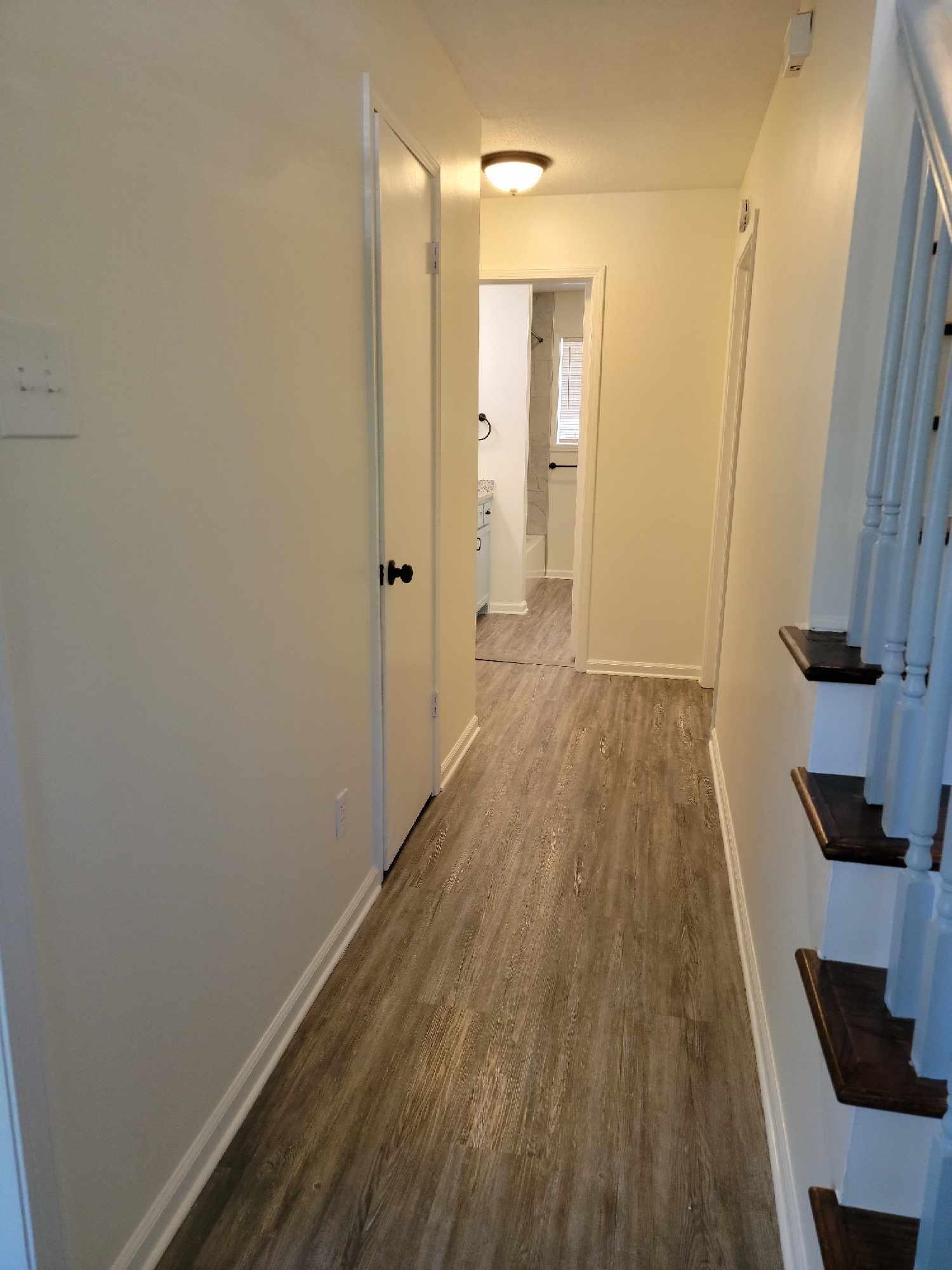 5231 Yellowood Road Memphis, TN 38134 - Photo 3 of 37 a view of a hallway with wooden floor and a bathroom
