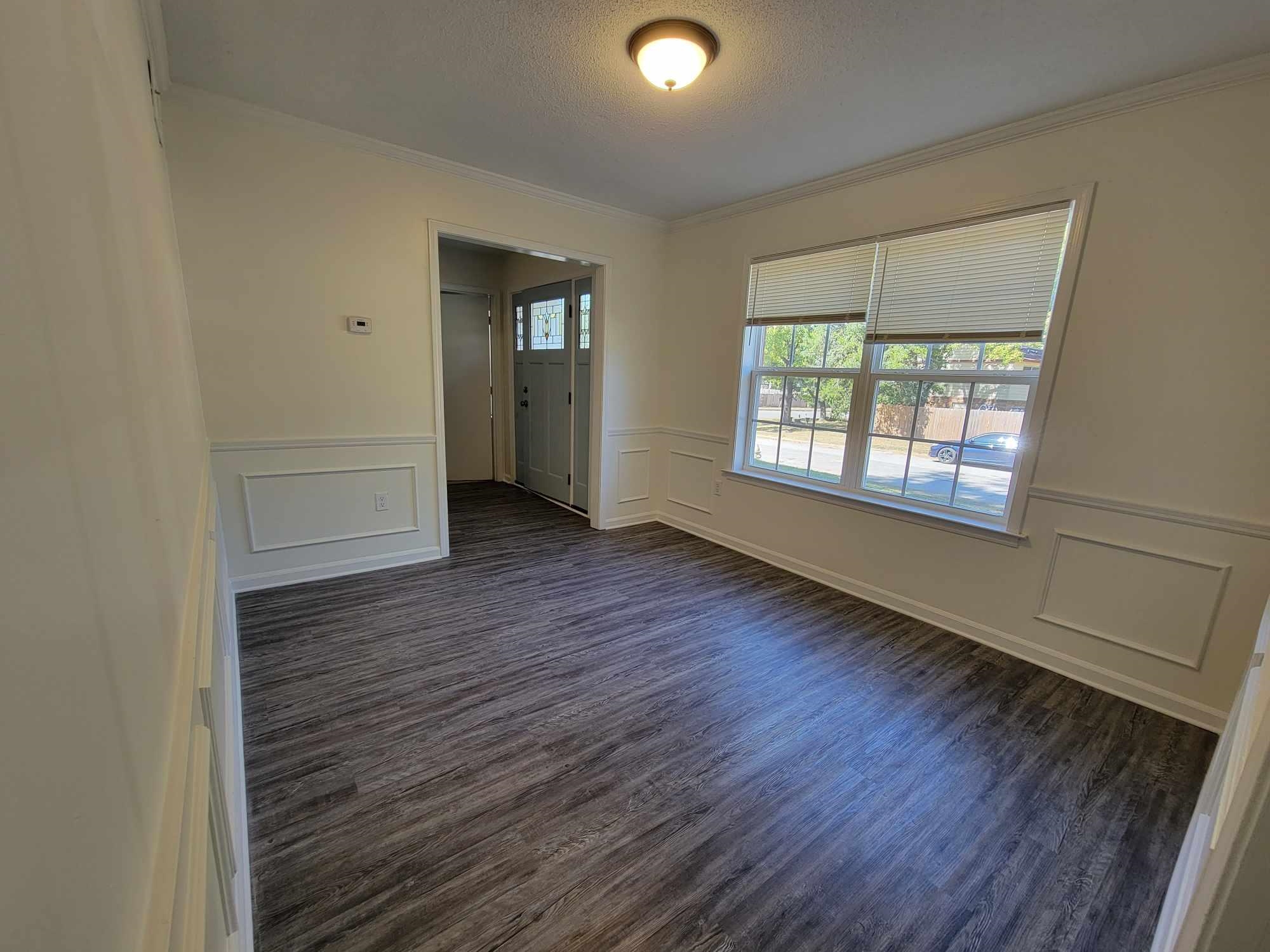 5231 Yellowood Road Memphis, TN 38134 - Photo 7 of 37 a view of an empty room with wooden floor and a window