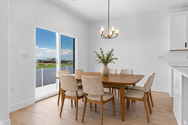 2362 1400 West, Unit 14 Perry, UT 84302 - Photo 6 of 22 Wood-finish flooring, white walls, and a sliding glass door