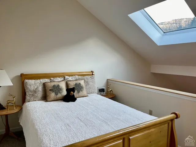 a bedroom with a bed and a lamp