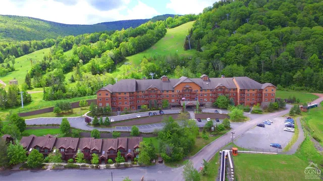 an aerial view of a houses with a garden and outdoor space