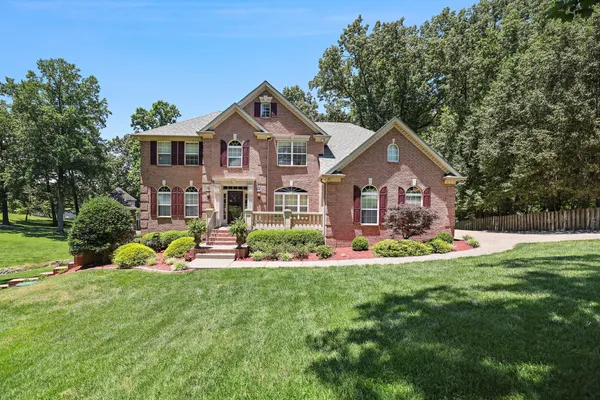 a front view of house with yard and outdoor seating