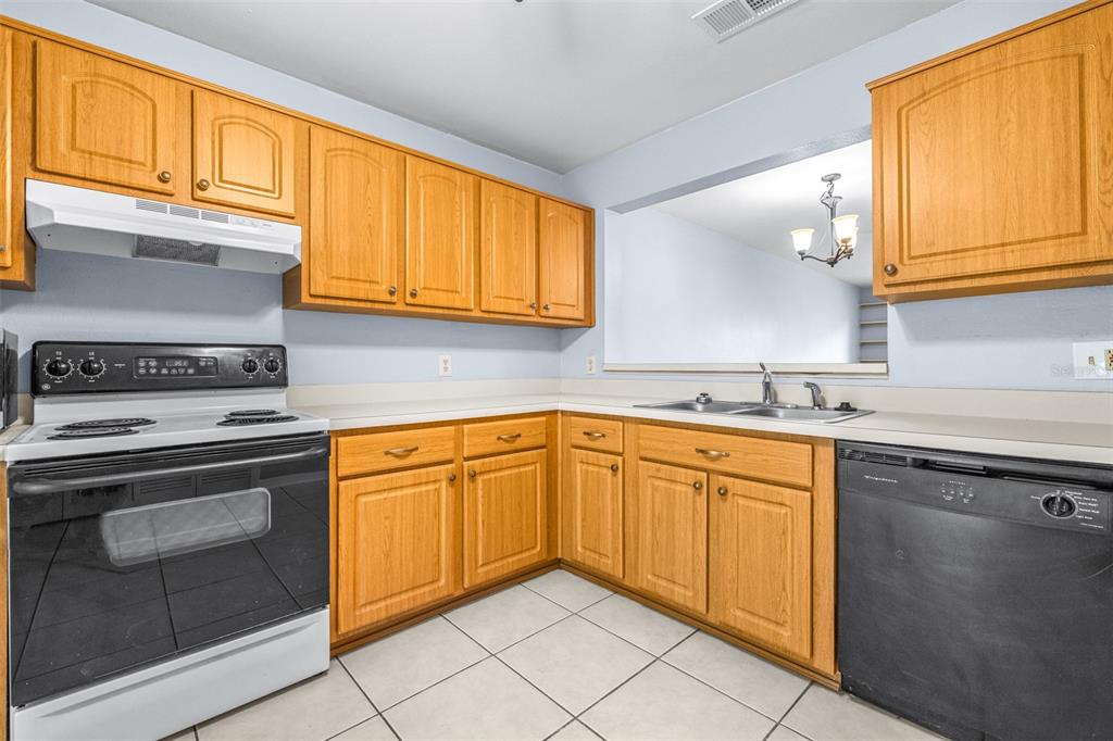5100 Burchette Road, Unit 4102 Tampa, FL 33647 - Photo 12 of 47 a kitchen with granite countertop cabinets stainless steel appliances and a sink