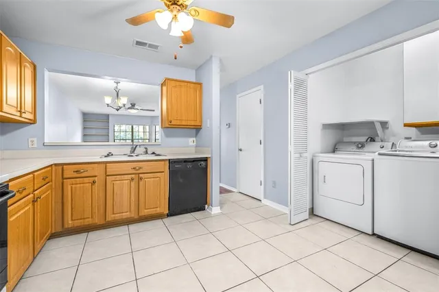 a kitchen with a sink cabinets and window