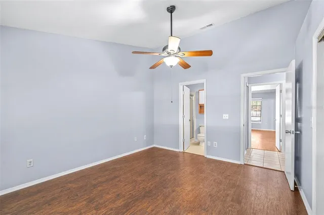 a view of a room with wooden floor and chandelier