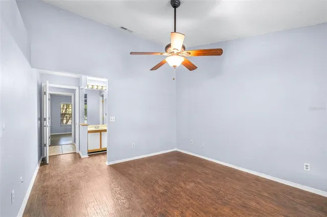 a view of a room with a hanging light and kitchen