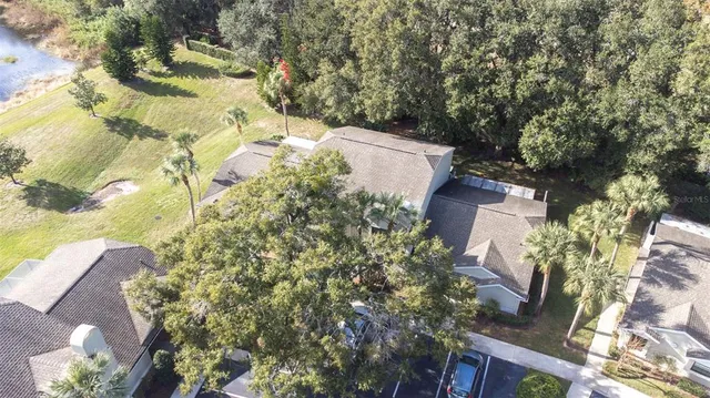 an aerial view of a house with yard