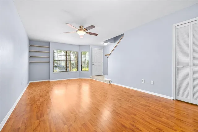 wooden floor in an empty room with a window