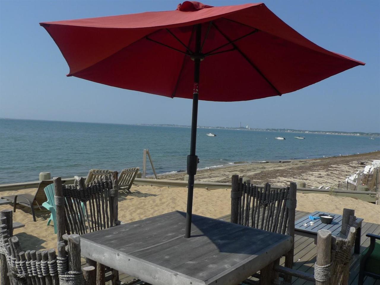 522 Shore Road, Unit 4 Truro, MA 02666 - Photo 1 of 12 a view of a terrace with furniture and umbrella
