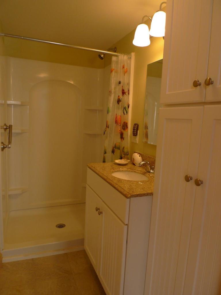 522 Shore Road, Unit 4 Truro, MA 02666 - Photo 10 of 12 a bathroom with a shower and a sink