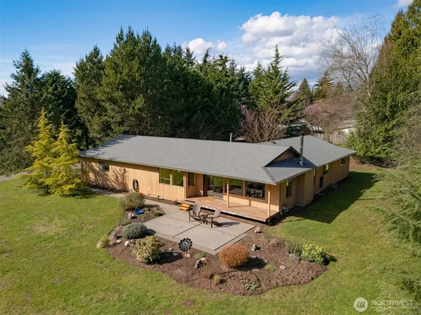 an aerial view of a house with swimming pool garden and patio