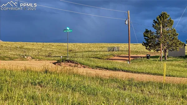 a view of a field with an ocean view