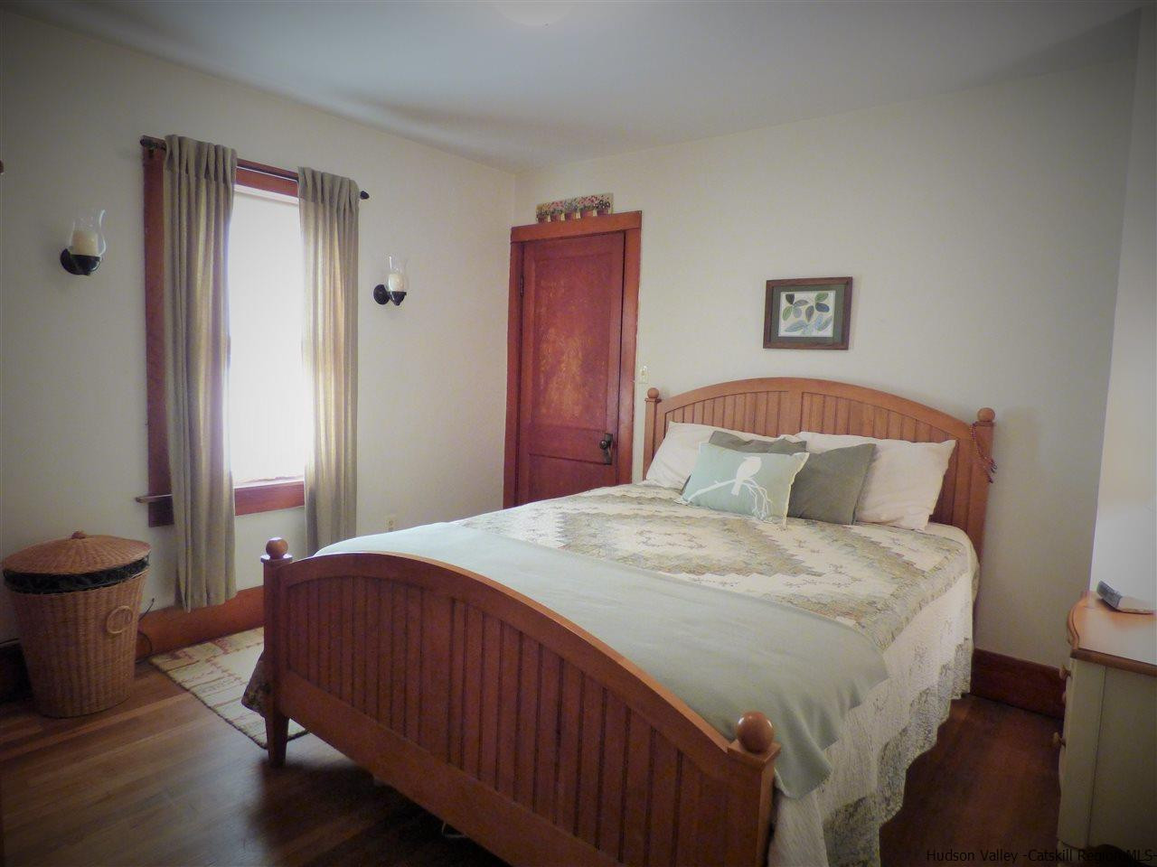 21 Crittenden Street Wallkill, NY 12589 - Photo 14 of 28 a bedroom with a bed and a lamp