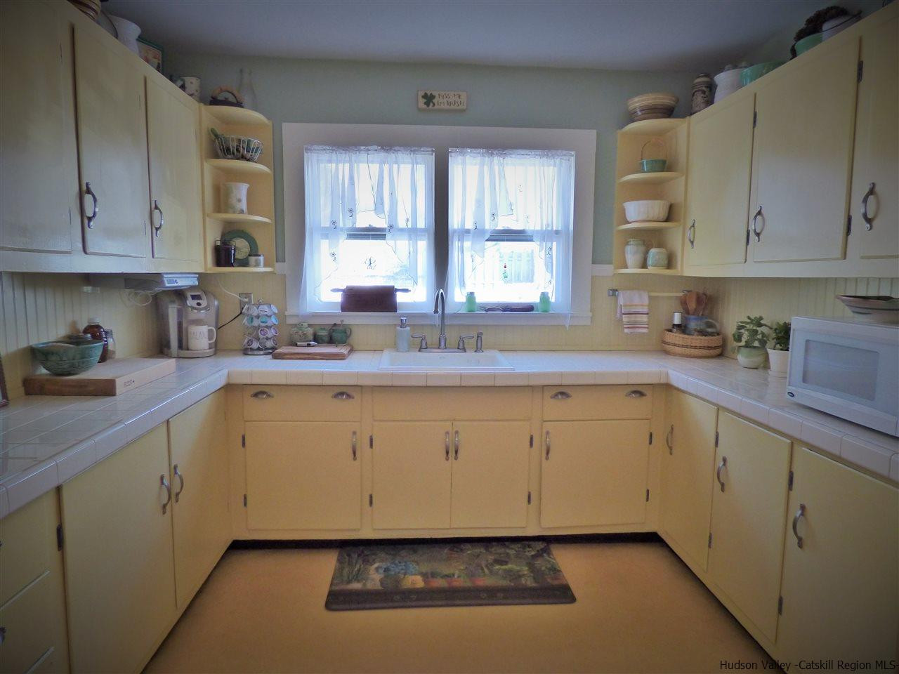 21 Crittenden Street Wallkill, NY 12589 - Photo 6 of 28 a kitchen with granite countertop white cabinets sink and window