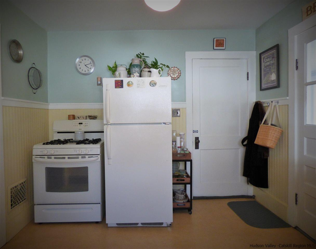 21 Crittenden Street Wallkill, NY 12589 - Photo 9 of 28 a white refrigerator freezer and a stove sitting inside of a kitchen