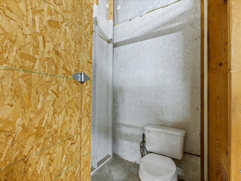 15742 Moody Road Oakland, IL 61943 - Photo 36 of 48 a white toilet sitting next to a shower curtain