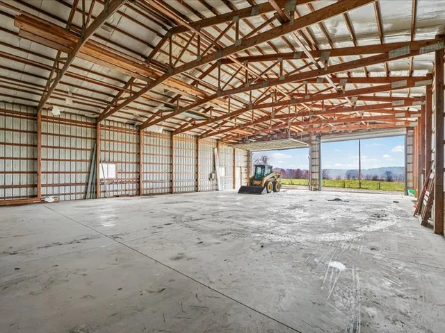 a view of a house with a yard and fence