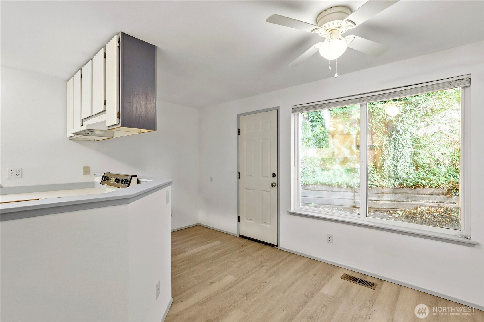 2800 Pine Road Northeast Bremerton, WA 98310 - Photo 6 of 38 a kitchen with granite countertop a stove and a wooden floor