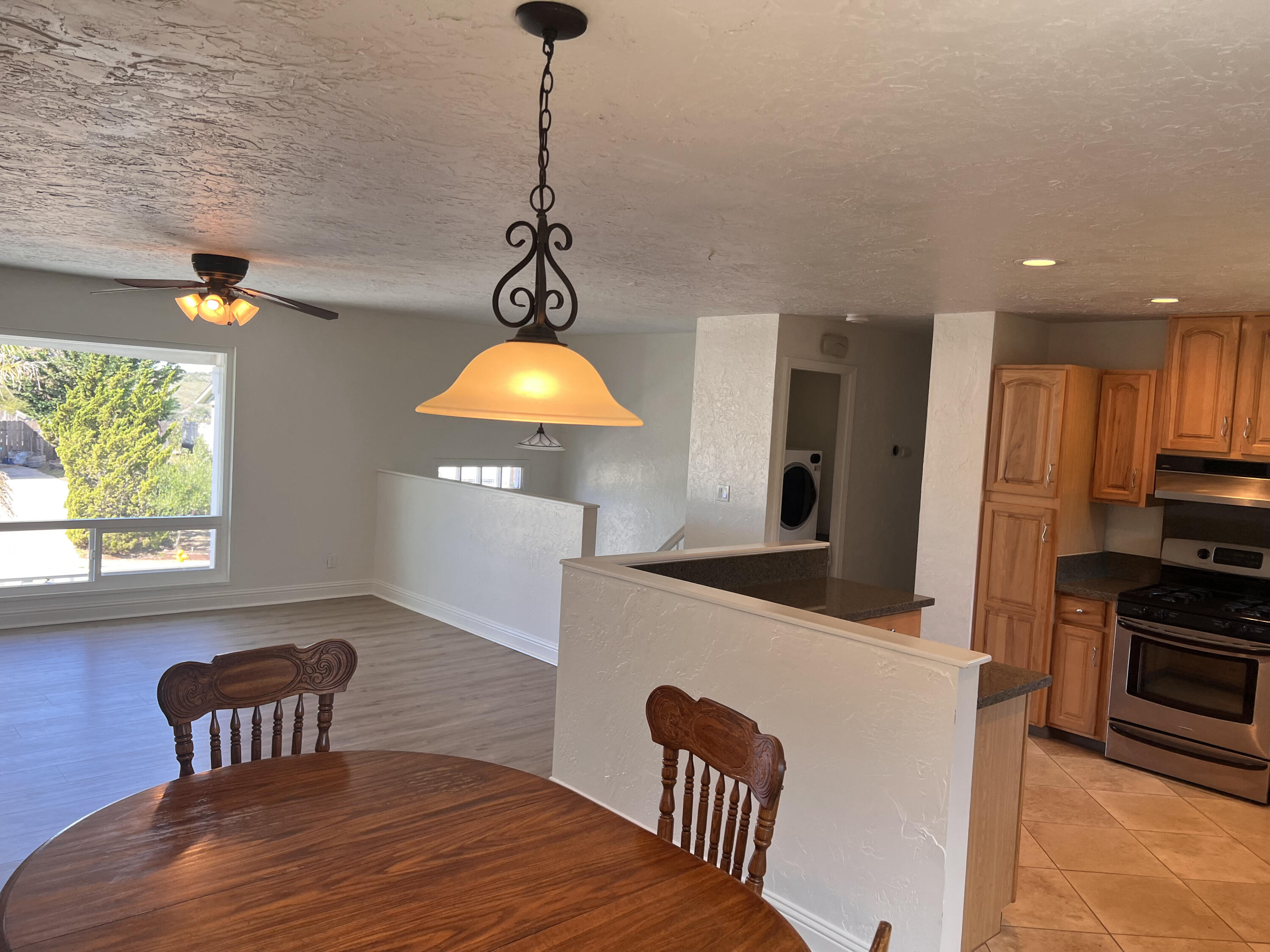 545 Sunbeam Road, Unit A Lompoc, CA 93436 - Photo 4 of 15 a kitchen with stainless steel appliances a dining table chairs and a wooden floor