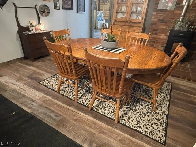 57285 New Castle Road Jerusalem, OH 43747 - Photo 5 of 38 Dining room with brick wall and dark hardwood / wood-style floors