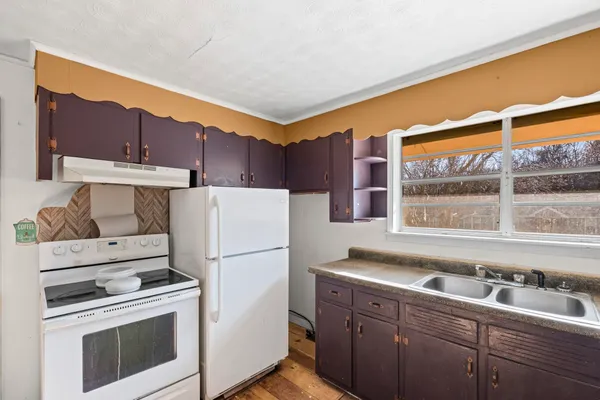 a kitchen with a sink cabinets and appliances
