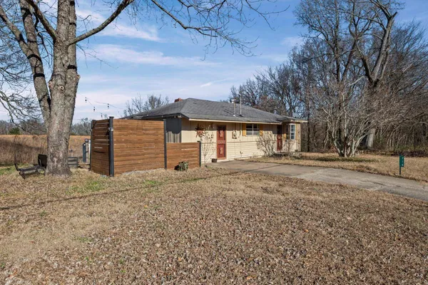 a backyard of a house with barbeque oven fire pit table and chairs