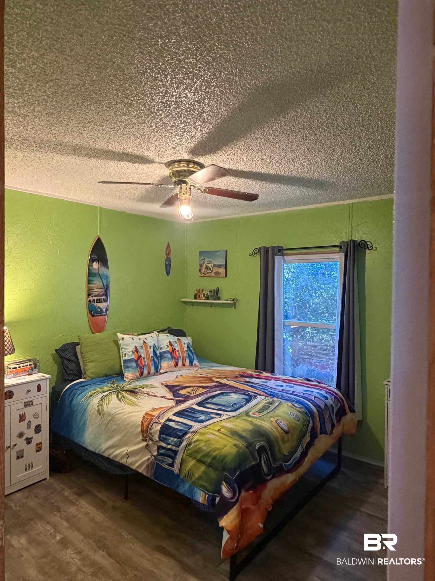 1127 Ridgewood Drive Lillian, AL 36549 - Photo 11 of 32 Bedroom featuring dark wood-style floors, ceiling fan, and a textured ceiling