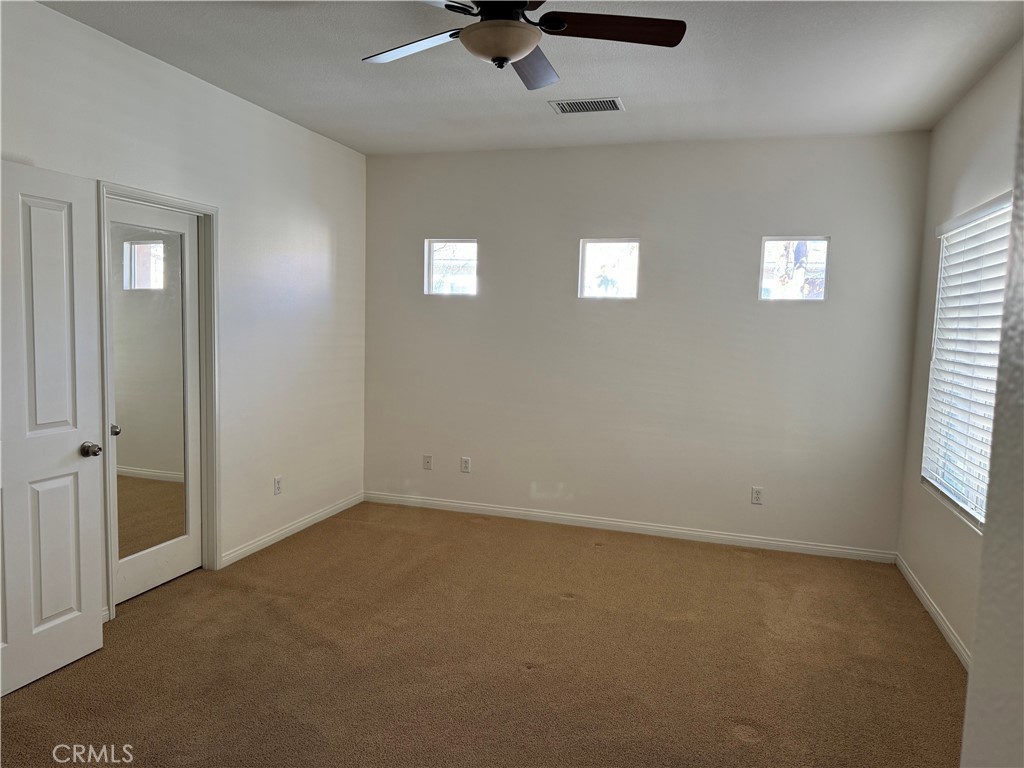 2986 Arbolitos Lane, Unit B Simi Valley, CA 93063 - Photo 14 of 36 an empty room with windows and fan
