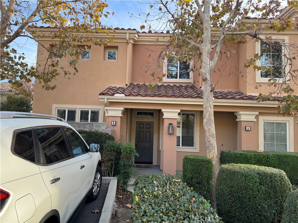 2986 Arbolitos Lane, Unit B Simi Valley, CA 93063 - Photo 2 of 36 a view of a white house with a large window and flower plants