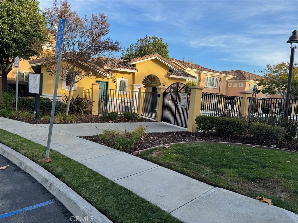 2986 Arbolitos Lane, Unit B Simi Valley, CA 93063 - Photo 32 of 36 a view of a white house with a big yard and large tree