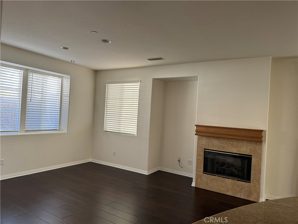 2986 Arbolitos Lane, Unit B Simi Valley, CA 93063 - Photo 6 of 36 an empty room with wooden floor fireplace and windows