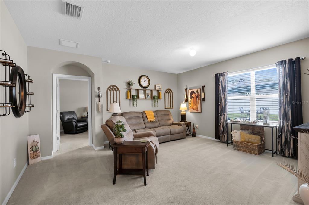 3016 Northeast 43rd Road Ocala, FL 34470 - Photo 13 of 35 a living room with furniture and a flat screen tv