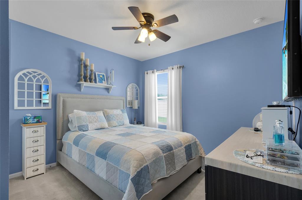 3016 Northeast 43rd Road Ocala, FL 34470 - Photo 15 of 35 a bedroom with a bed and a chandelier